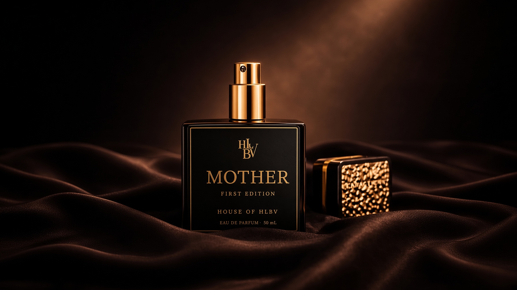 MOTHER First Edition resting on dark silk, its gold cap set beside it in a single shaft of light.